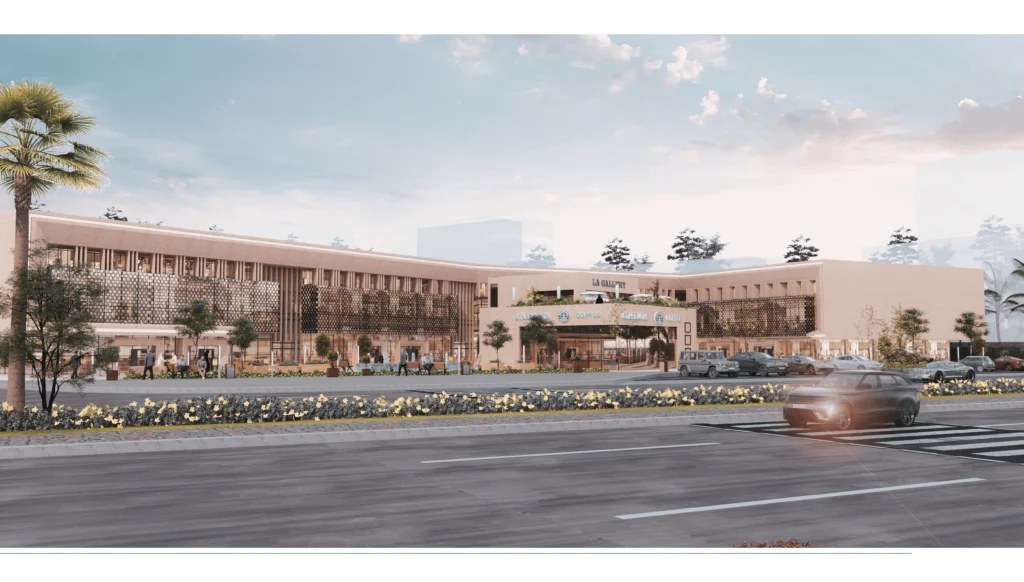 Wide 3D architectural daytime rendering of a modern commercial shopping plaza featuring La Gallery and Starbucks, with a beige facade, street-level parking, and landscaping.